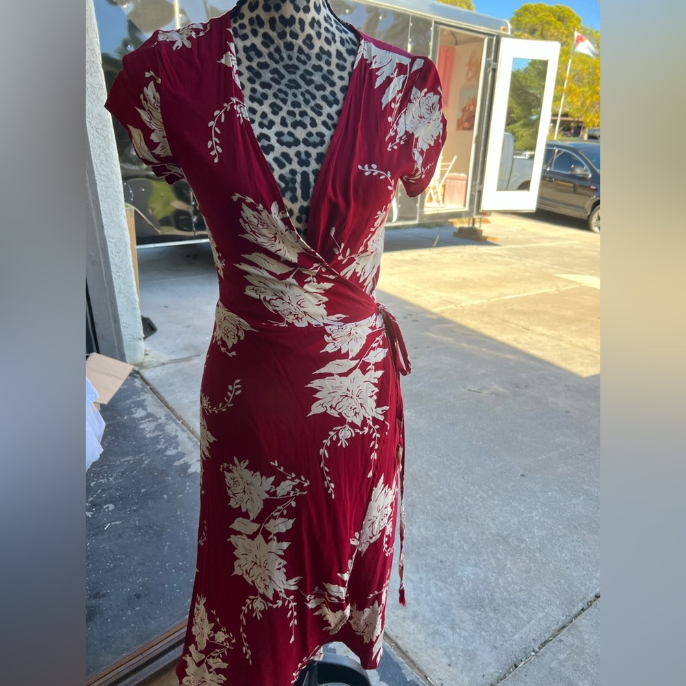 Red with white floral, wrap around dress.
